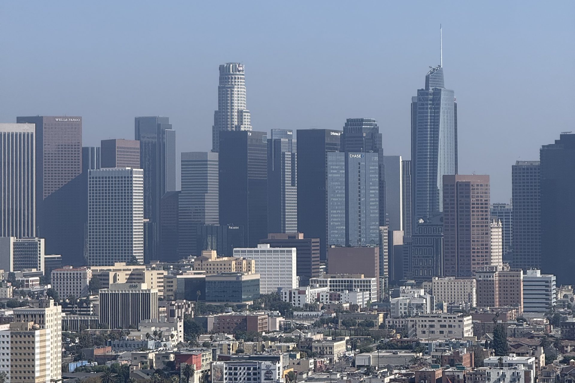 The downtown Los Angeles skyline seen from the east across low-rise rooftops