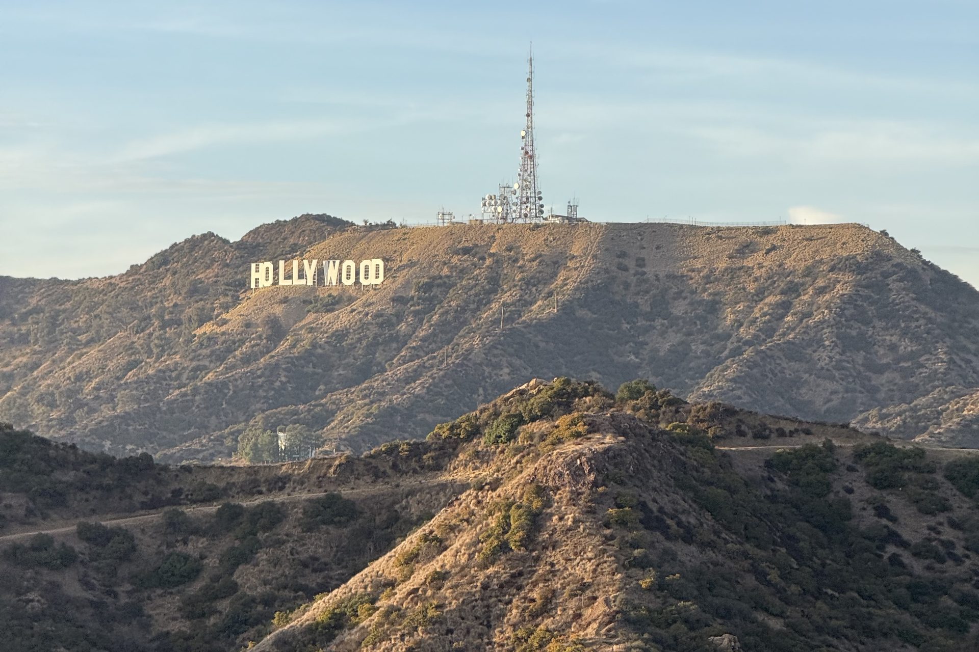 The Hollywood sign on the ridge below the Mount Lee transmitter, seen across the Hollywood Hills