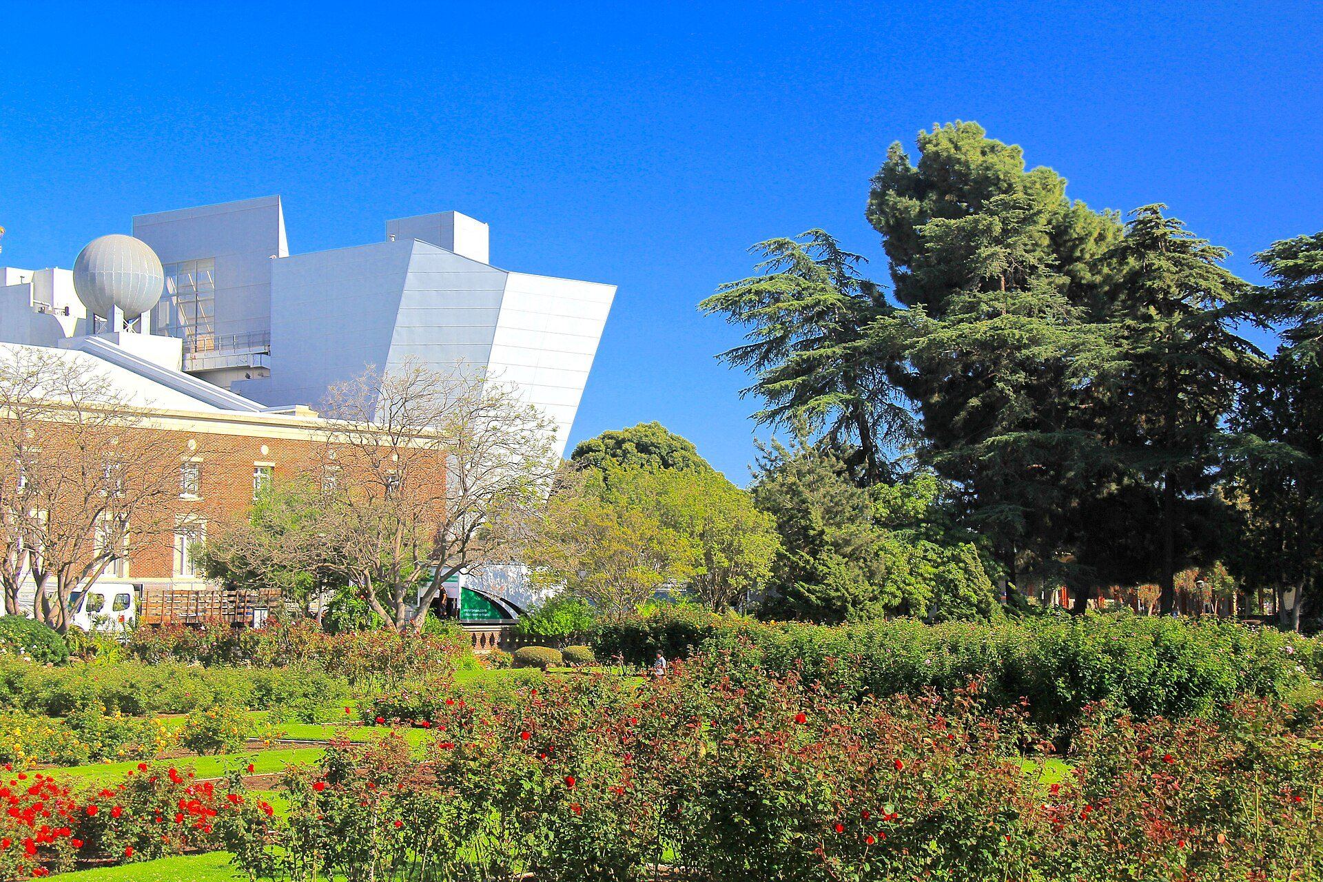 The rose garden at Exposition Park, with the California Science Center behind it