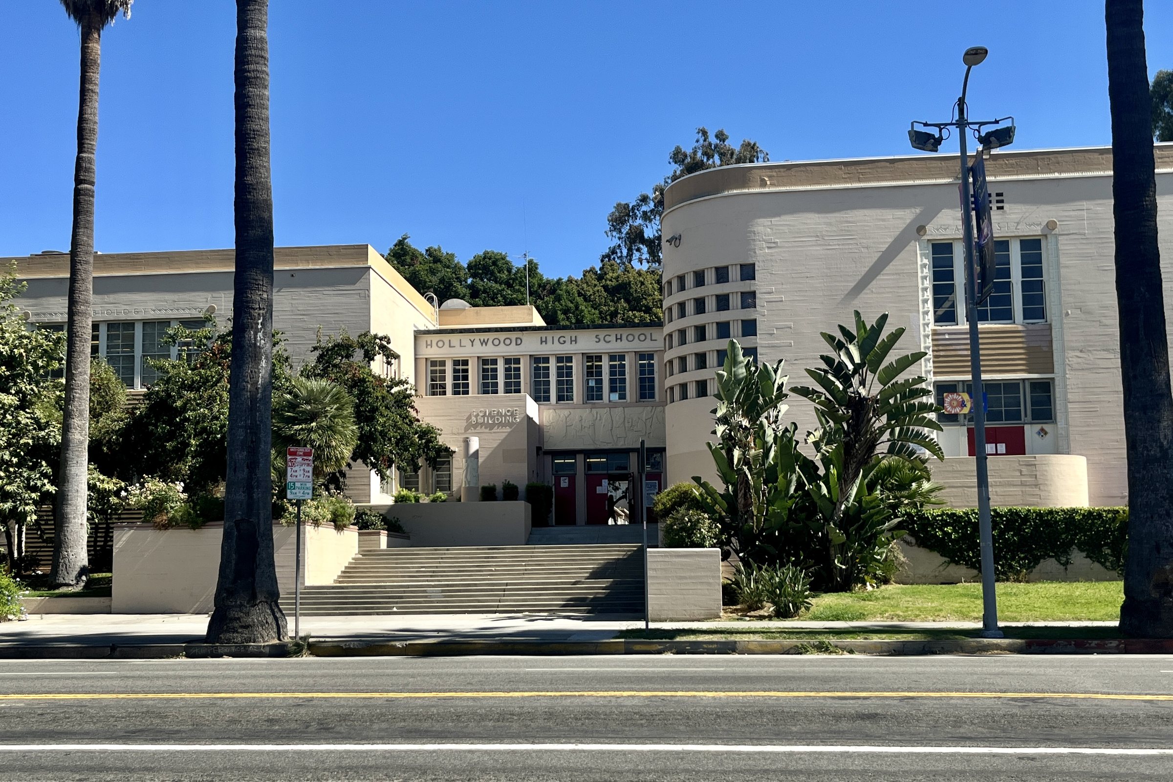 The science building at Hollywood High School, with palms along the sidewalk out front