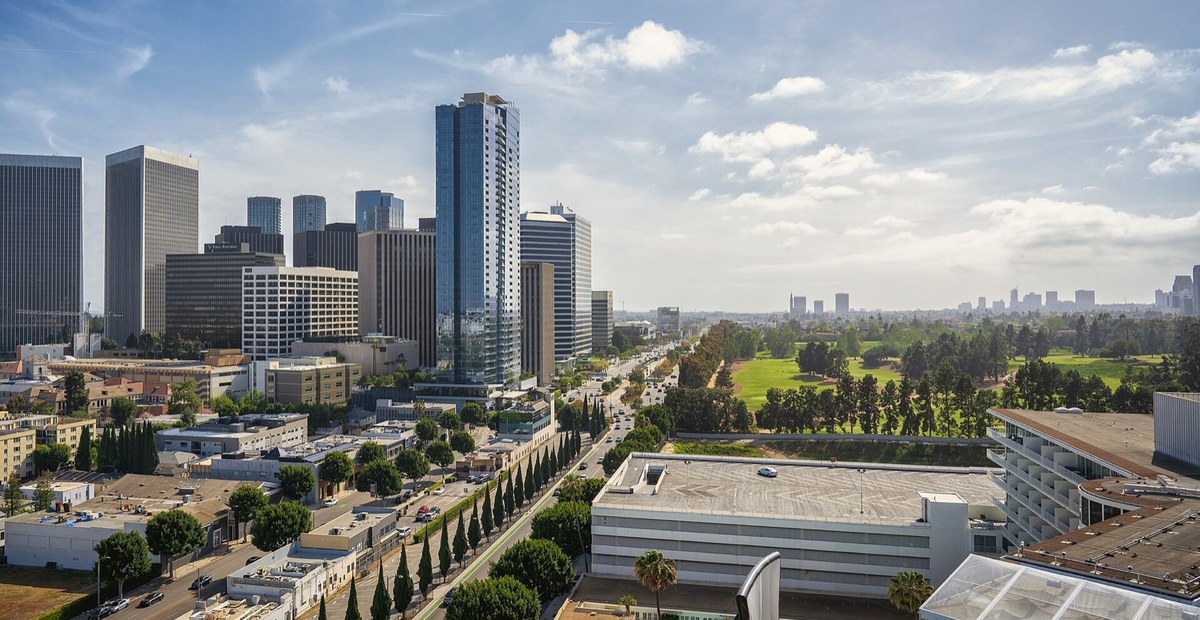 The Century City towers on one side of Santa Monica Boulevard and the fairways of the Los Angeles Country Club on the other.